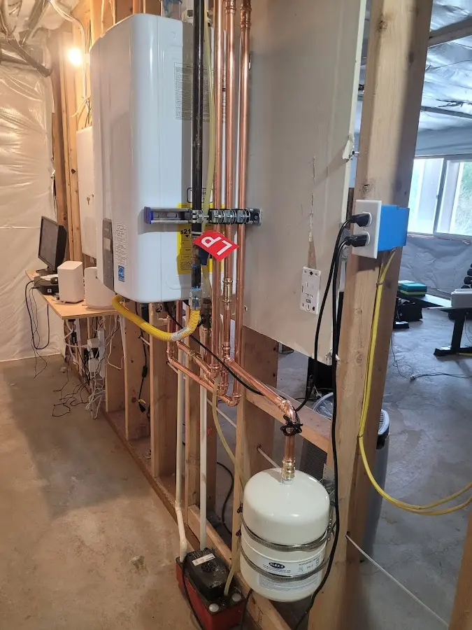 Licensed plumber repairing a kitchen sink in Stanhope